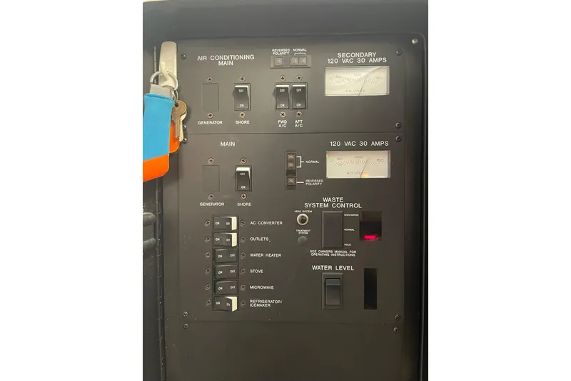 Slide: The Image of Control panel of a 1992 Sea Ray 370 Express Cruiser with various switches and gauges. - 7