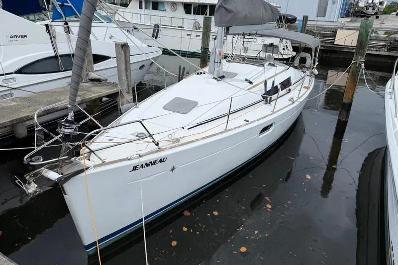 The Image of 2011 Jeanneau Sun Odyssey 36i sailboat docked in a marina, side view. - 1