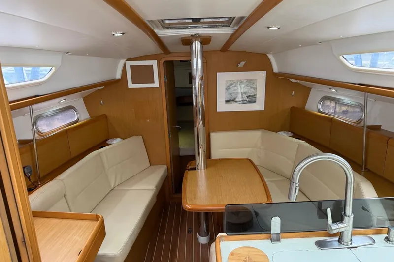 Slide: The Image of Interior of 2011 Jeanneau Sun Odyssey 36i sailboat with cozy seating and modern design. - 10