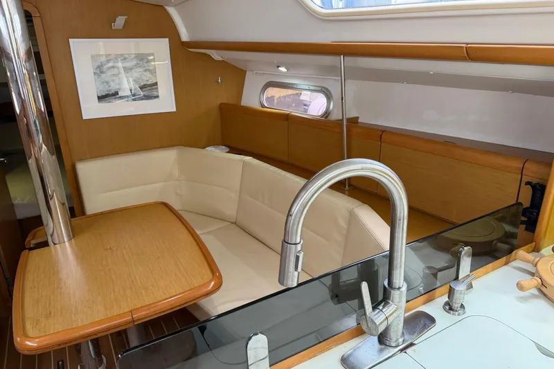 Slide: The Image of Interior of 2011 Jeanneau Sun Odyssey 36i sailboat with cozy seating and modern kitchen area. - 14