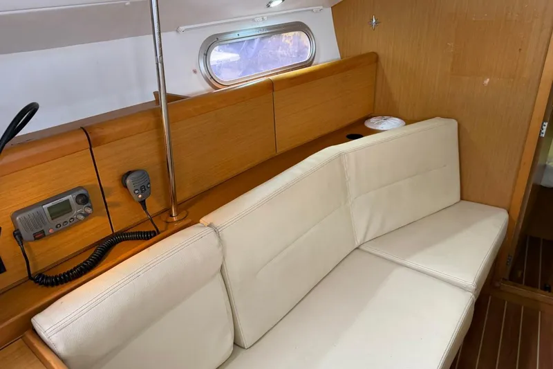 Slide: The Image of Interior of 2011 Jeanneau Sun Odyssey 36i with beige seating and wooden accents. - 18