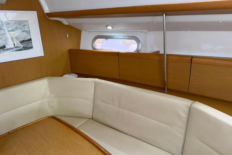 Slide: The Image of Interior of 2011 Jeanneau Sun Odyssey 36i yacht with beige seating and wooden accents. - 19