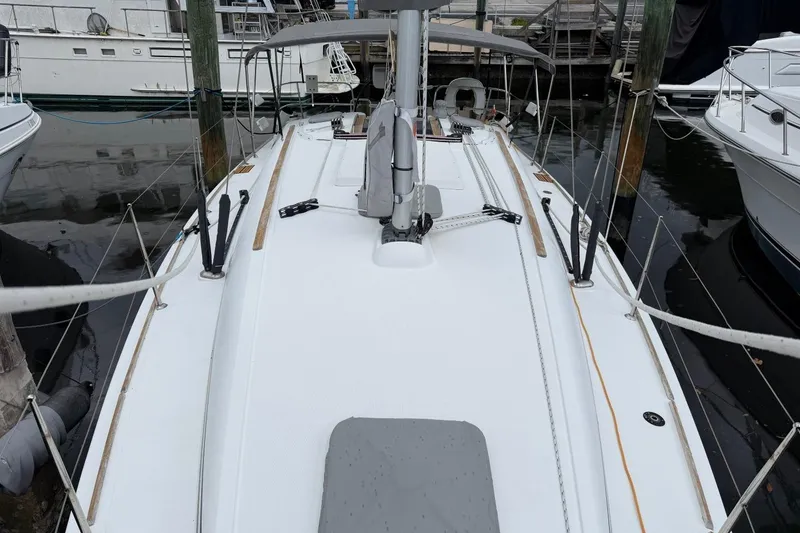 Slide: The Image of 2011 Jeanneau Sun Odyssey 36i sailboat docked at marina, view of deck and rigging. - 2