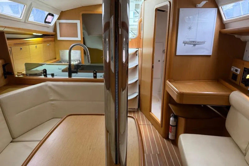 Slide: The Image of Interior of 2011 Jeanneau Sun Odyssey 36i yacht, featuring modern kitchen and seating area. - 21