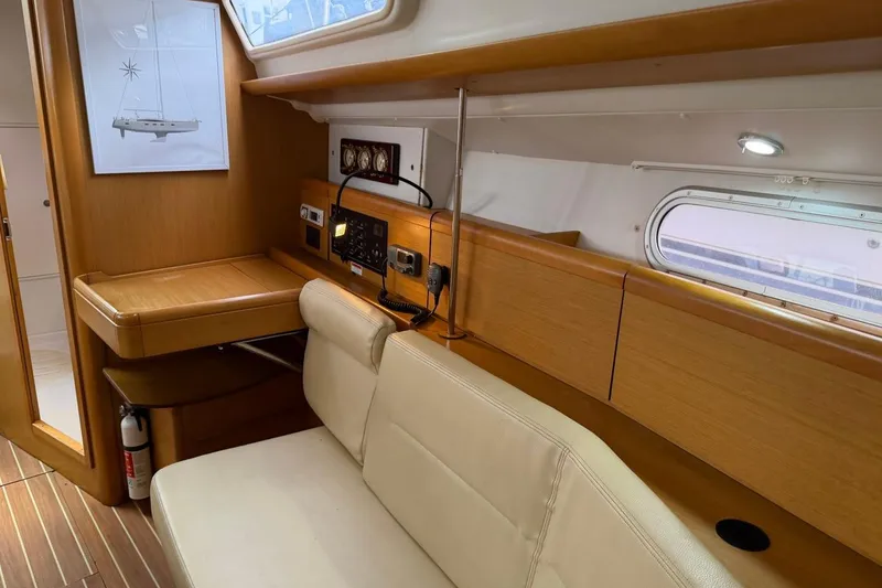 Slide: The Image of Interior of 2011 Jeanneau Sun Odyssey 36i yacht with wooden finish and seating area. - 22