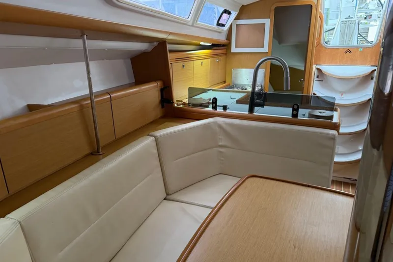 Slide: The Image of Interior of 2011 Jeanneau Sun Odyssey 36i sailboat with cozy seating and modern kitchen. - 23
