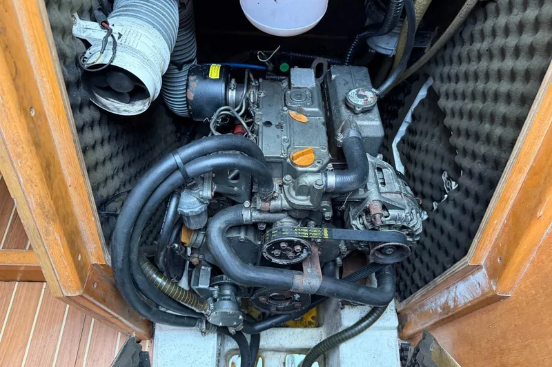 Slide: The Image of Engine compartment of a 2011 Jeanneau Sun Odyssey 36i sailboat, showcasing mechanical components. - 24