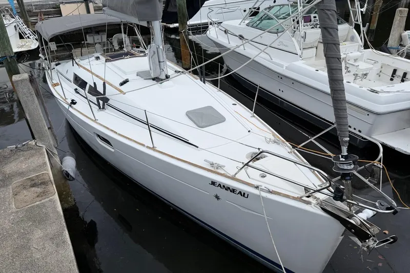 Slide: The Image of 2011 Jeanneau Sun Odyssey 36i sailboat docked in a marina, showcasing sleek design. - 27