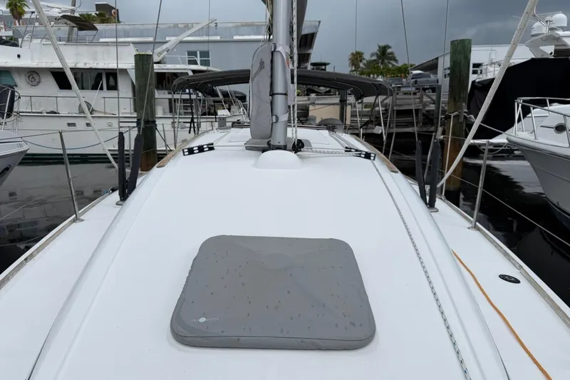 Slide: The Image of 2011 Jeanneau Sun Odyssey 36i sailboat deck view at marina, surrounded by other boats. - 3