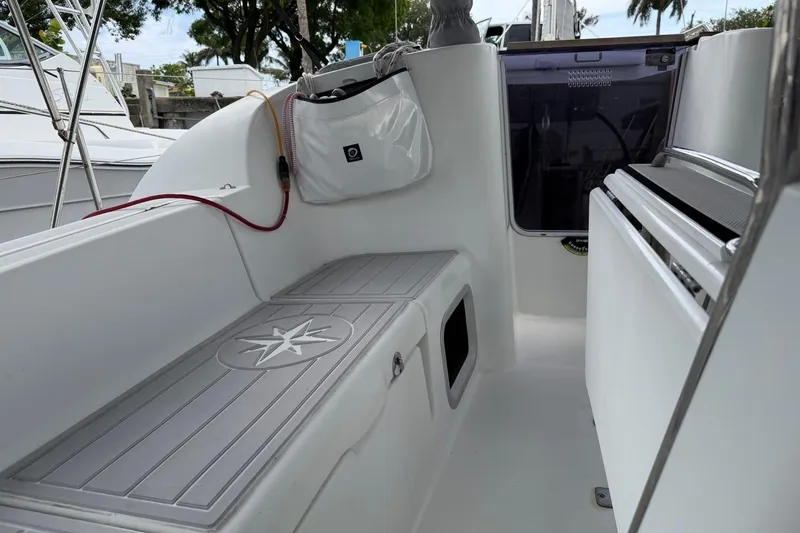 Slide: The Image of Cockpit of 2011 Jeanneau Sun Odyssey 36i sailboat, featuring sleek white design and storage compartments. - 7