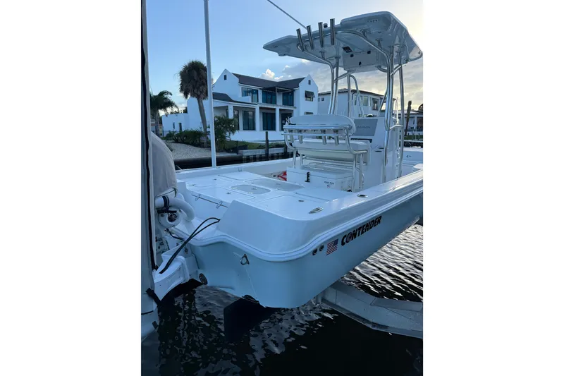 Slide: The Image of 2024 Contender 26 Bay boat docked near waterfront homes. - 5