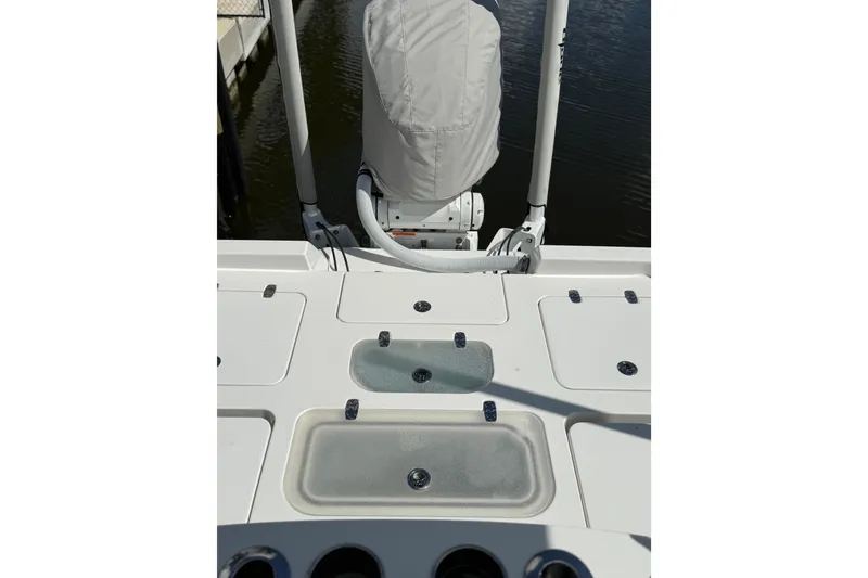Slide: The Image of 2024 Contender 26 Bay boat deck with storage compartments and covered motor. - 7