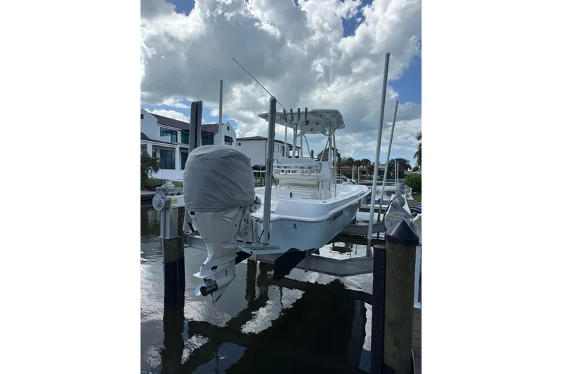 Slide: The Image of 2024 Contender 26 Bay boat docked under cloudy sky. - 9