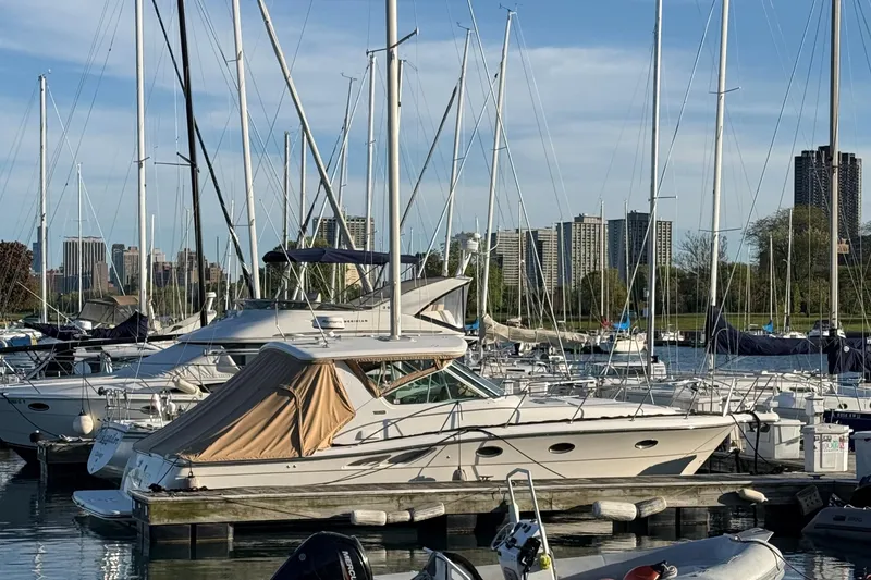 Slide: The Image of 2003 Tiara Yachts 3500 Open docked in a marina with city skyline backdrop. - 1