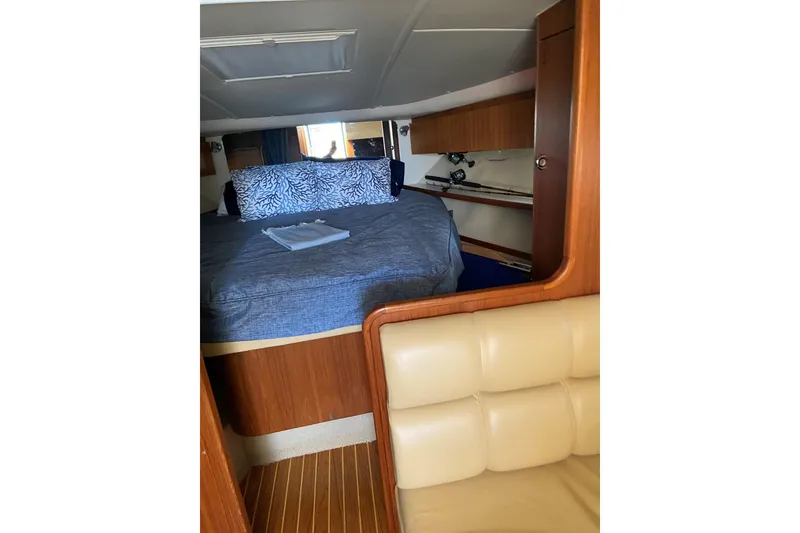 Slide: The Image of 2003 Tiara Yachts 3500 Open cabin interior with bed and wooden accents. - 11