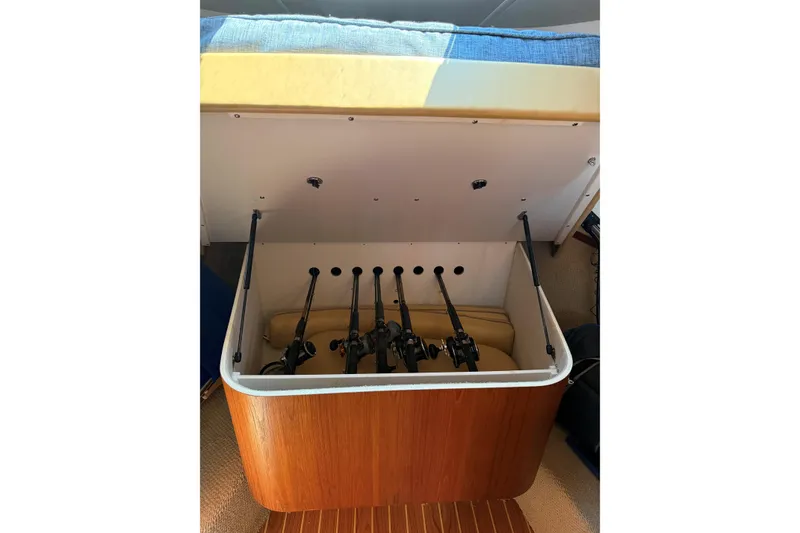 Slide: The Image of Storage compartment with fishing rods on a 2003 Tiara Yachts 3500 Open. - 12