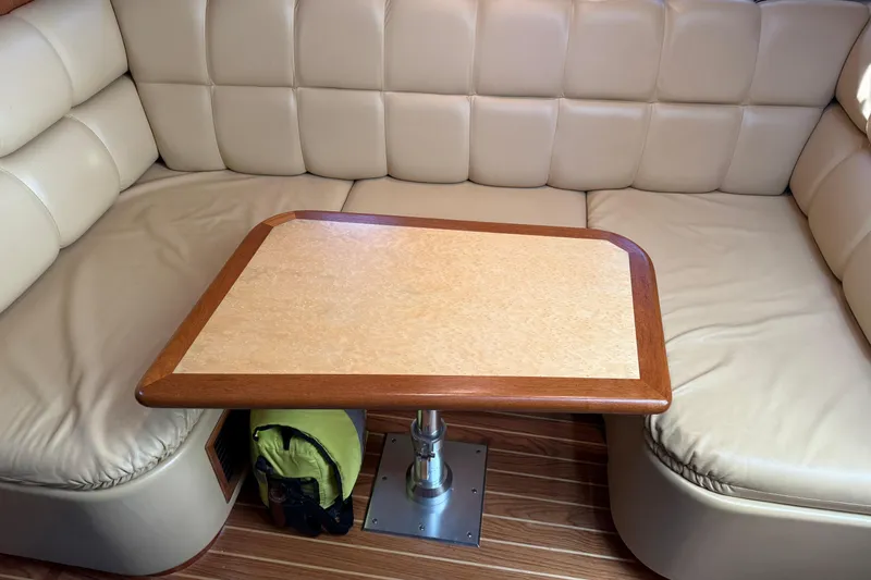 Slide: The Image of Luxurious interior of 2003 Tiara Yachts 3500 Open with beige seating and wooden table. - 14