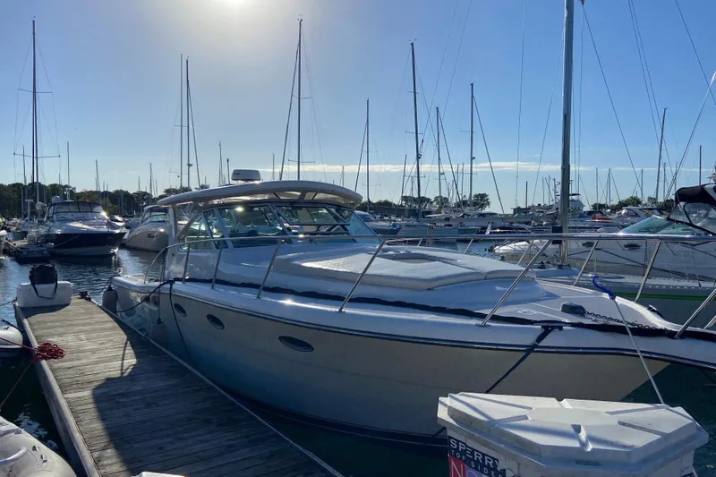 Slide: The Image of 2003 Tiara Yachts 3500 Open docked at marina under clear sky. - 3