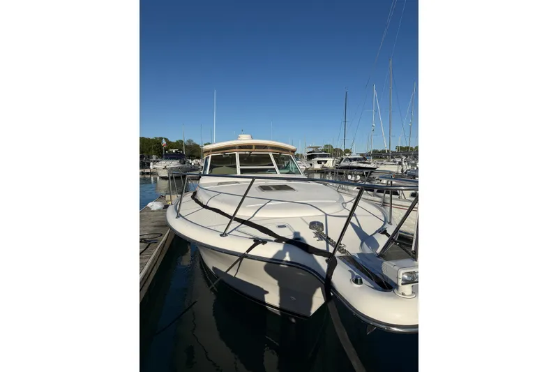 Slide: The Image of 2003 Tiara Yachts 3500 Open docked at marina under clear blue sky. - 5