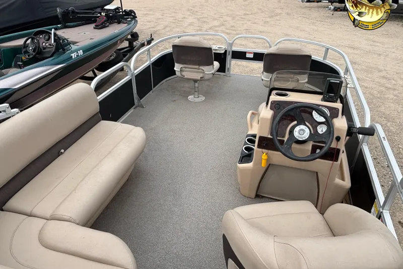 Slide: The Image of 2017 Sun Tracker Bass Buggy 18 DLX pontoon boat interior with seating and steering console. - 5