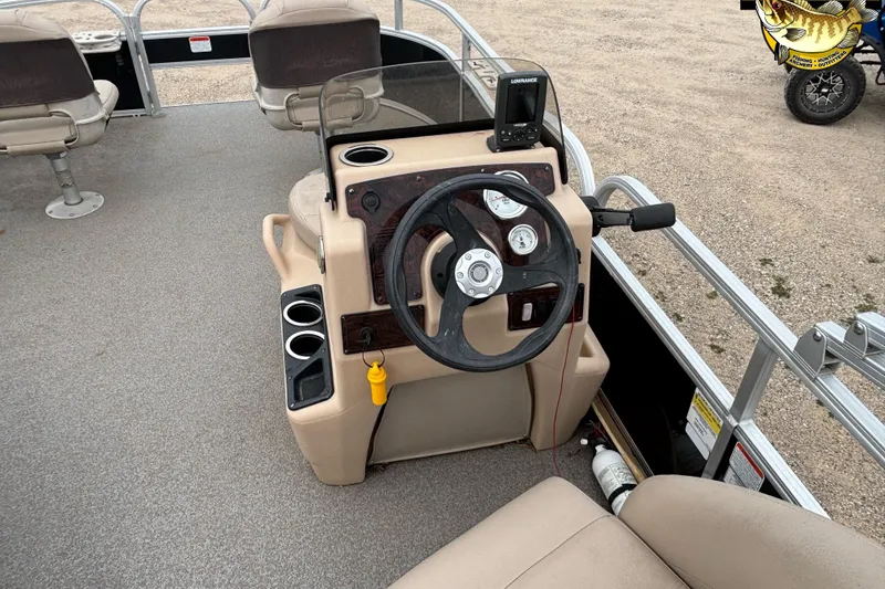 Slide: The Image of 2017 Sun Tracker Bass Buggy 18 DLX boat interior with steering console and seating. - 6