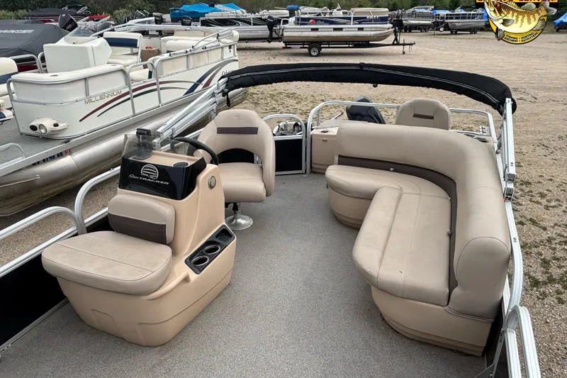 Slide: The Image of 2017 Sun Tracker Bass Buggy 18 DLX pontoon boat with beige seating and steering console. - 8