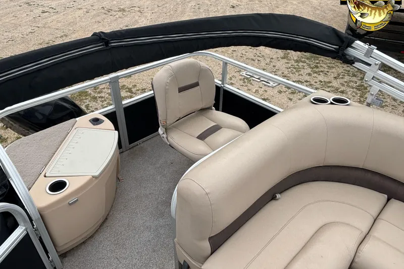 Slide: The Image of 2017 Sun Tracker Bass Buggy 18 DLX interior with beige seating and fishing station. - 9