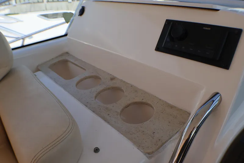 Slide: The Image of 2009 Tiara Yachts 3500 Sovran interior with cup holders and audio controls. - 12