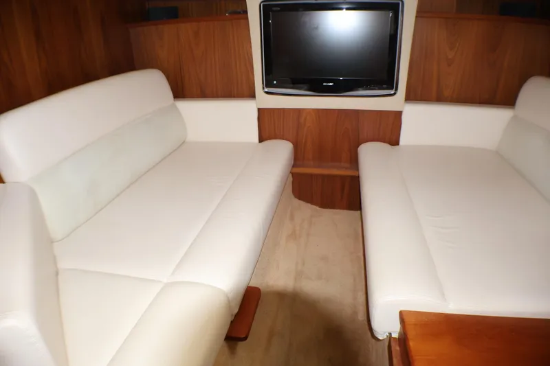 Slide: The Image of Interior of 2009 Tiara Yachts 3500 Sovran with white seating and wall-mounted TV. - 15