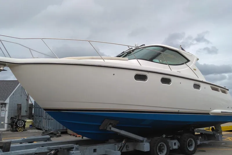 Slide: The Image of 2009 Tiara Yachts 3500 Sovran on trailer, showcasing sleek design and blue hull. - 2