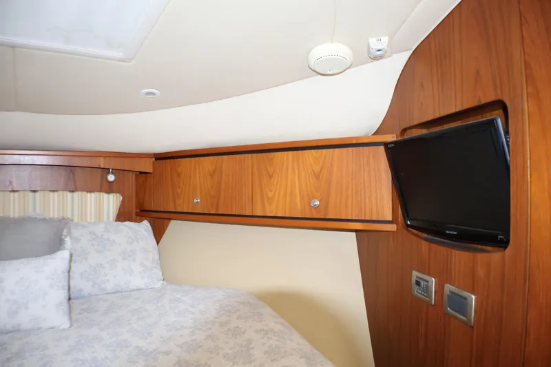 Slide: The Image of Interior cabin of 2009 Tiara Yachts 3500 Sovran with wood paneling and mounted TV. - 23