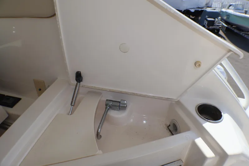 Slide: The Image of 2009 Tiara Yachts 3500 Sovran boat compartment with open hatch and faucet. - 26