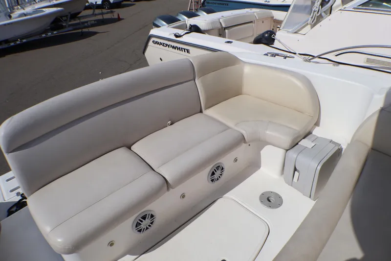 Slide: The Image of 2009 Tiara Yachts 3500 Sovran seating area with beige upholstery and storage compartment. - 27