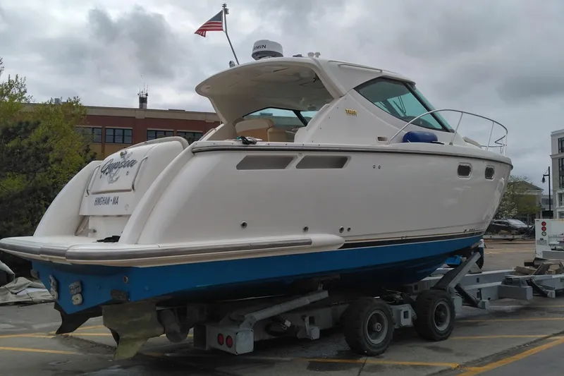 Slide: The Image of 2009 Tiara Yachts 3500 Sovran on trailer, docked in a marina setting. - 3