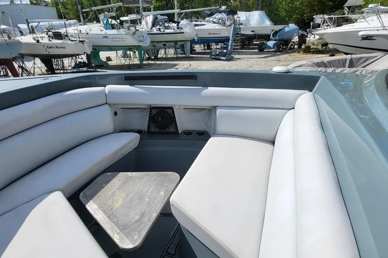 Slide: The Image of 2023 Aviara AV32 OB boat interior with cushioned seating and wooden table. - 10