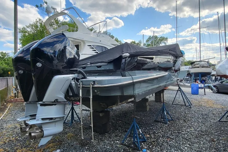 Slide: The Image of 2023 Aviara AV32 OB boat with dual outboard engines on a gravel lot. - 17