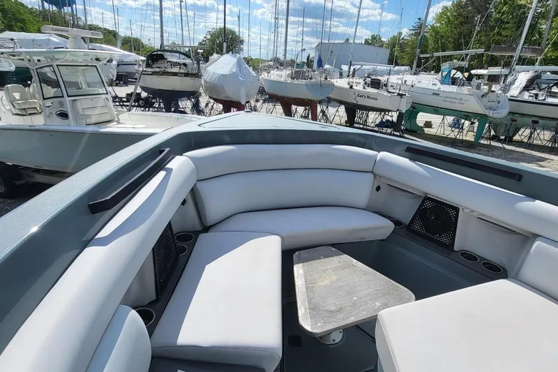 Slide: The Image of 2023 Aviara AV32 OB boat with spacious seating and table, docked among other boats. - 9