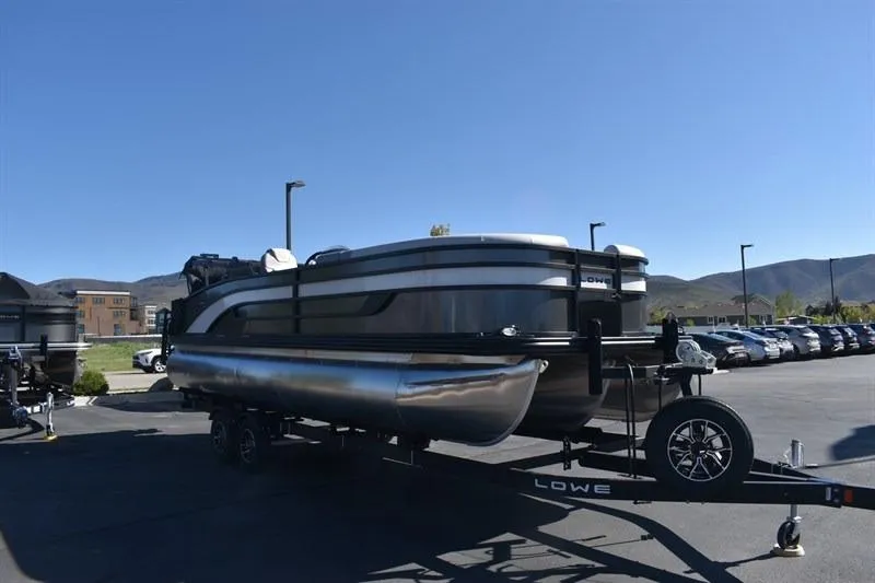 Slide: The Image of 2026 Lowe SF 232 WT Sport Fish pontoon boat on trailer in parking lot. - 11