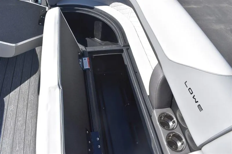 Slide: The Image of 2026 Lowe SF 232 WT Sport Fish boat interior with storage compartment and cup holders. - 15