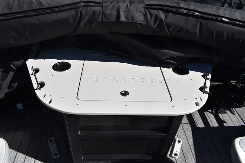 Slide: The Image of 2026 Lowe SF 232 WT Sport Fish boat deck with storage compartment and cup holders. - 25