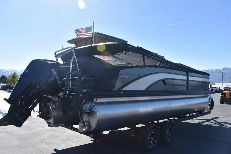 Slide: The Image of 2026 Lowe SF 232 WT Sport Fish pontoon boat on trailer, sunny day. - 3