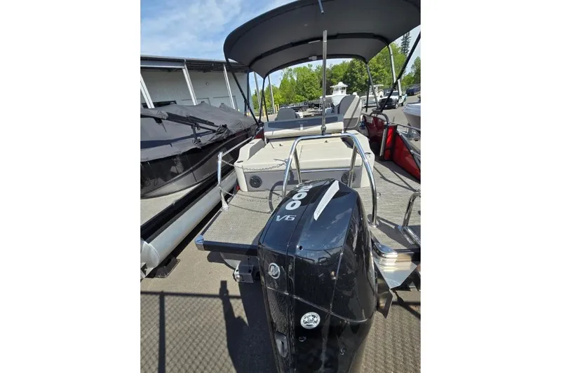 Slide: The Image of 2024 Barletta C22UC pontoon boat with powerful V6 engine, docked under sunny skies. - 3