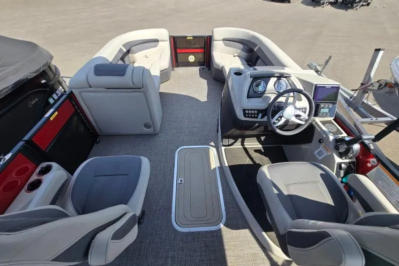 Slide: The Image of 2024 Barletta C22UC pontoon boat interior with plush seating and modern helm controls. - 6