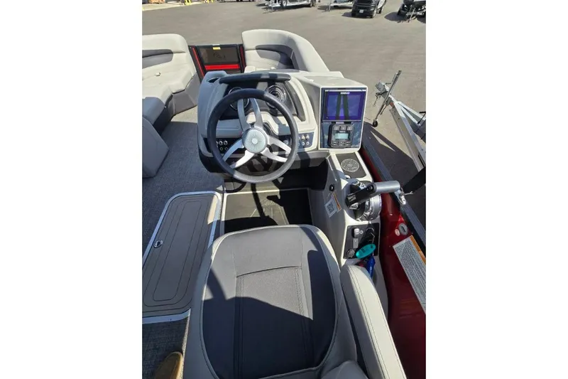 Slide: The Image of 2024 Barletta C22UC boat cockpit with steering wheel and control panel. - 7