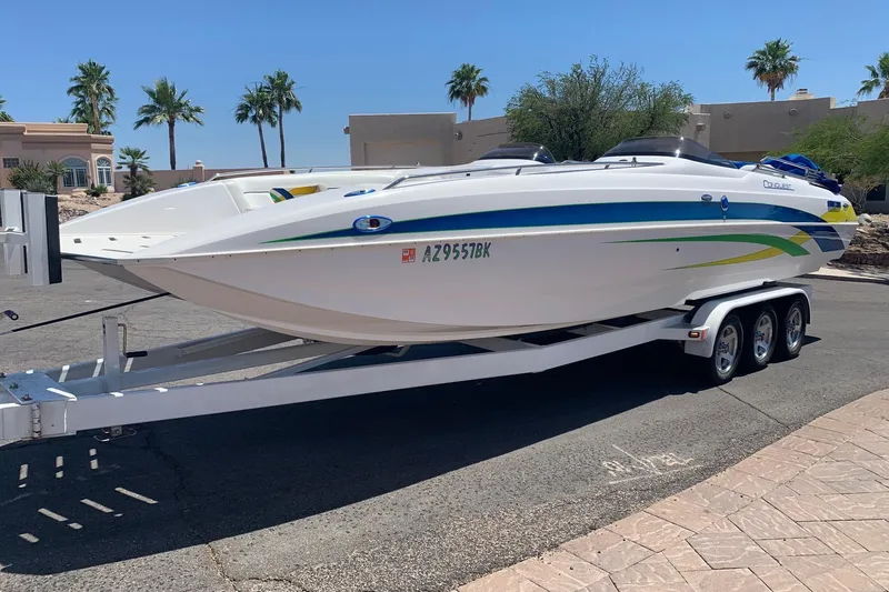 Slide: The Image of 2006 Conquest 28 Top Cat II boat on trailer, parked in sunny residential area. - 1