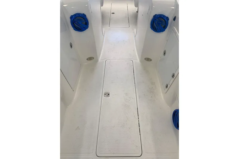 Slide: The Image of 2006 Conquest 28 Top Cat II boat interior with white deck and blue accents. - 10
