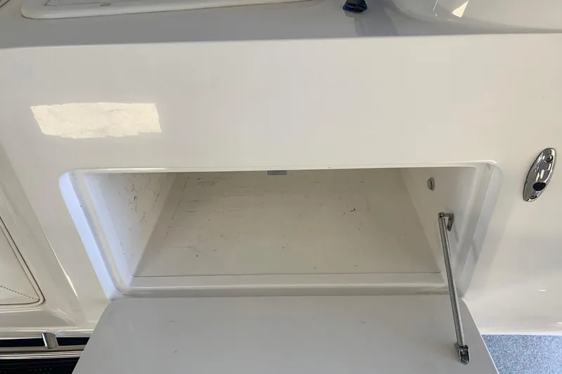 Slide: The Image of Open storage compartment on a 2006 Conquest 28 Top Cat II boat. - 11