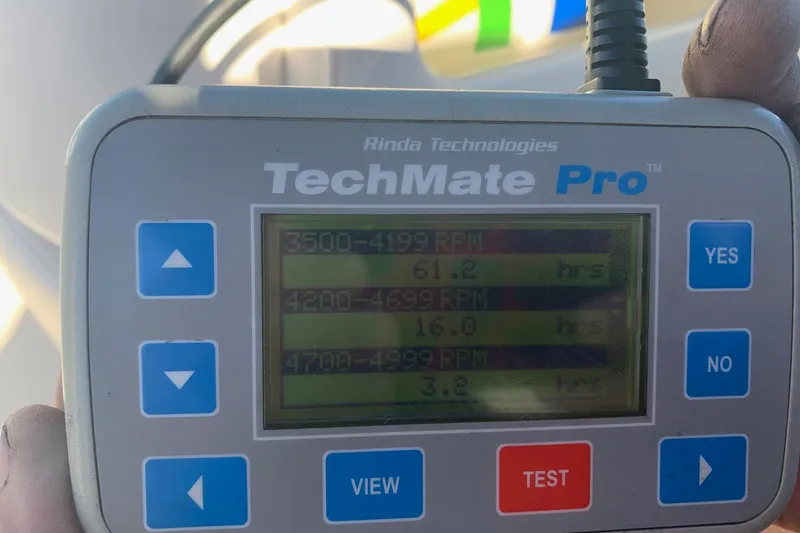 Slide: The Image of TechMate Pro device displaying RPM hours for Conquest 28 Top Cat II, 2006 model. - 19