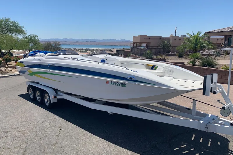 Slide: The Image of 2006 Conquest 28 Top Cat II boat on trailer, parked near waterfront homes. - 22