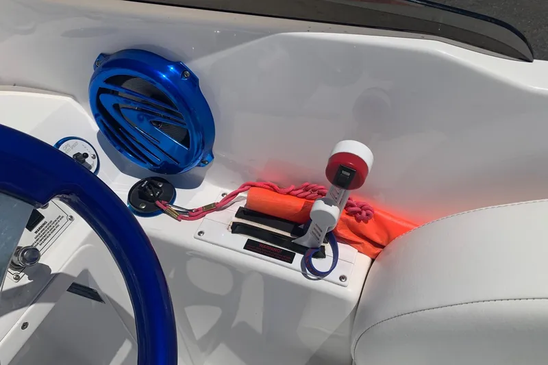 Slide: The Image of 2006 Conquest 28 Top Cat II boat interior with blue speaker and steering wheel. - 6